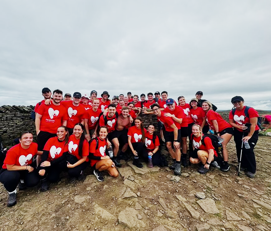 A large group of Mitchy Foundation supporters in red shirts gathered on the Yorkshire Three Peaks challenge route.